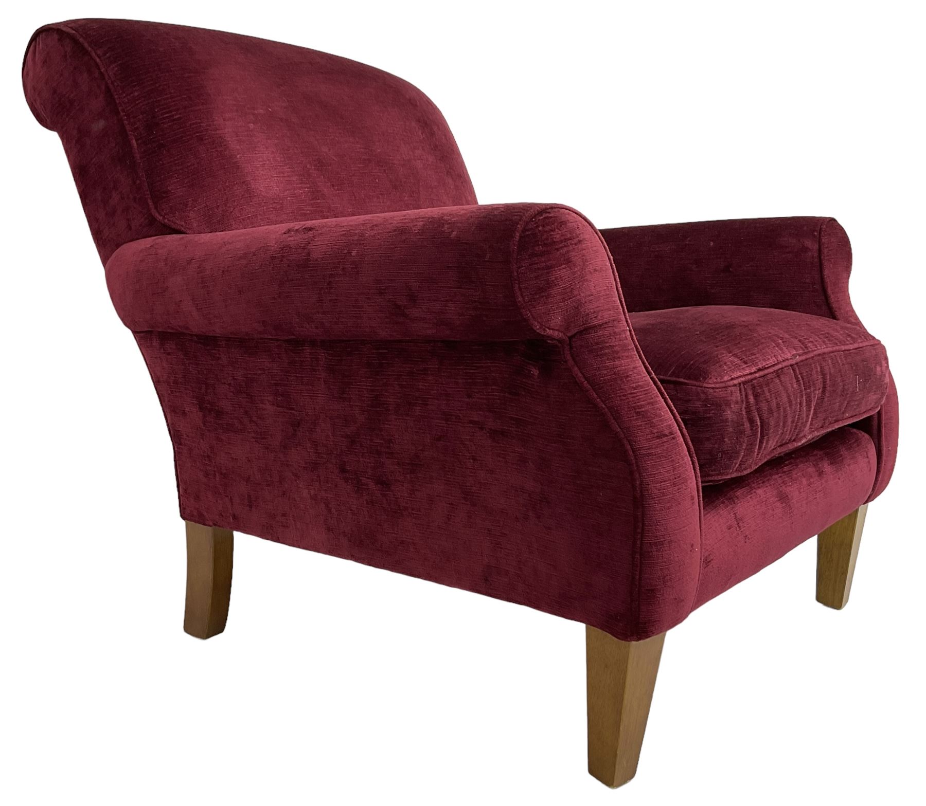 Duresta - traditional shape armchair upholstered in burgundy red velvet, on square tapering front supports (W88cm, H85cm, D103cm); together with a matching rectangular footstool with hinged seat, on turned feet with brass castors (73cm x 54cm, H38cm)