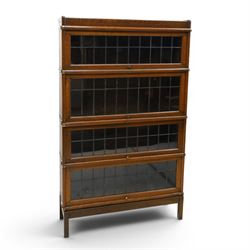 Globe Wernicke - oak four tier barrister bookcase, with leaded glazed fronts, raised on sq...