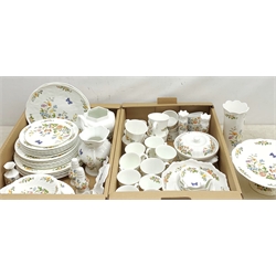 A large quantity of Aynsley Cottage Garden dinner and tea wares, to include dinner plates, dessert plates, side plates, bowls, serving dish, serving dish and cover, ramekins, cruets, mugs, large jug, pair of candle sticks, various vases, pin dishes, etc. 