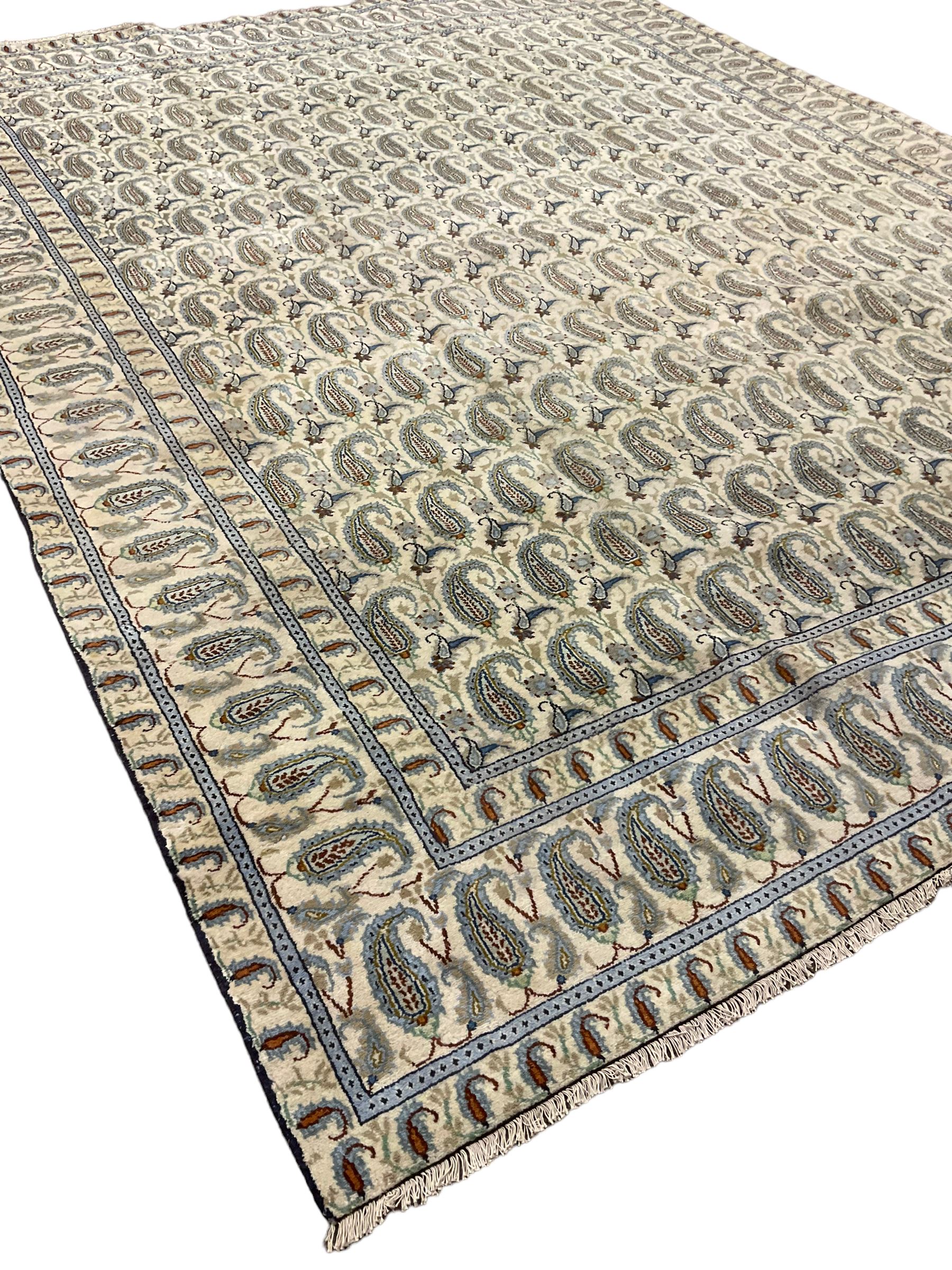 Central Persian Kashan ivory ground carpet, decorated with repeating Boteh motifs, the three band border decorated with further Boteh motifs