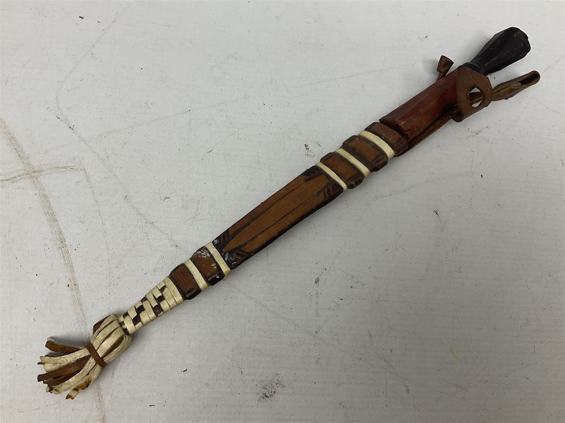 Indian kukri with 29cm curving steel blade and nickel mounted horn grip; in leather covered scabbard with one skinning knife L42cm overall; Hitler Youth knife with scabbard in relic condition; and three African graduated knives each with crudely carved wooden grips and painted leather covered scabbards (5)