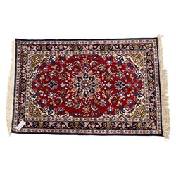 Two Central Persian rugs, ivory ground with a symmetrical foliate and floral design around a shaped cartouche medallion with a red floral and bird motif border with contrasting guard stripes, 142x76cm, Central Persian Kashan rug, crimson central field with a floral and foliate design with a stylized rosette medallion incorporating palmettes and scrolling vine work, enclosed by a dark navy border and multiple guard stripes, 117x68cm, (2)