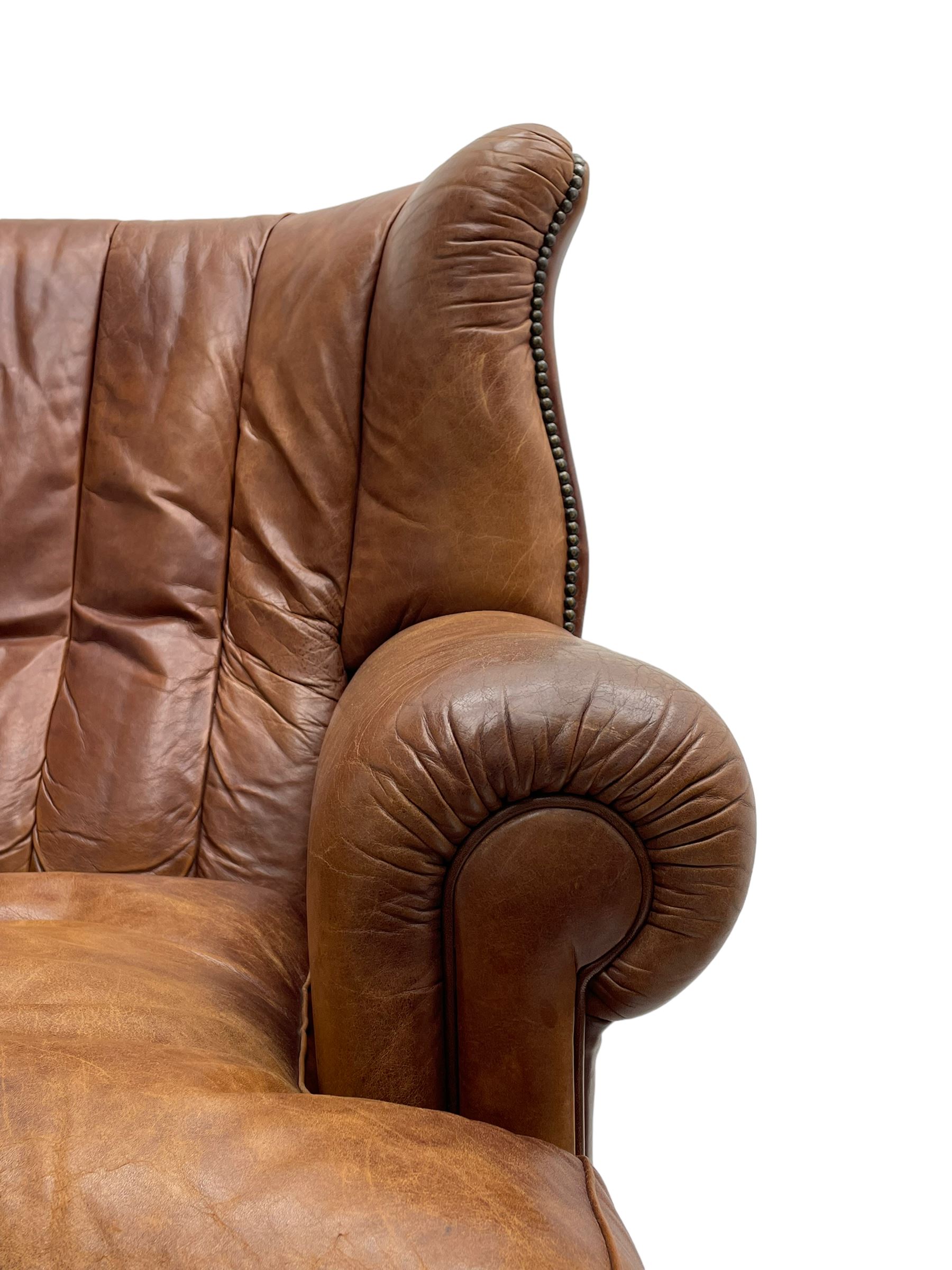 Tetrad - 'Blake' club armchair, fanned wingback and rolled arms upholstered in tan brown leather, on ball and claw carved cabriole feet 