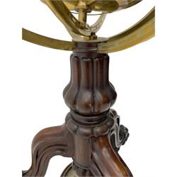 19th century brass terrestrial armillary sphere on rosewood base, lobe carved column on three splayed supports with scrolled carved terminals, the supports united by circular compass with turned stretchers