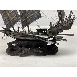 Chinese miniature silver model of a junk ship, with textured sails, mounted upon a carved wooden stand, H14cm