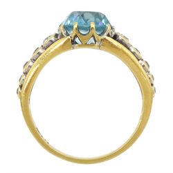Early 20th century gold round blue zircon ring, the pierced shoulders set with five round graduating old cut diamonds either side, stamped 18ct 