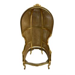 French style gilt wood and cane bergère porter's chair, the canopy top carved with flowers, barrelled back with double cane work, on cabriole supports