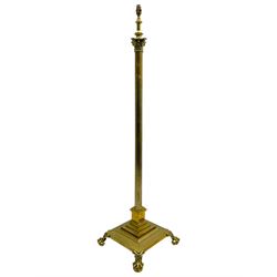 Late 20th century brass telescopic standard lamp in the form of a Corinthian column, Corinthian acanthus leaf capital over reeded shaft, stepped and moulded square base with four extending ball and claw feet