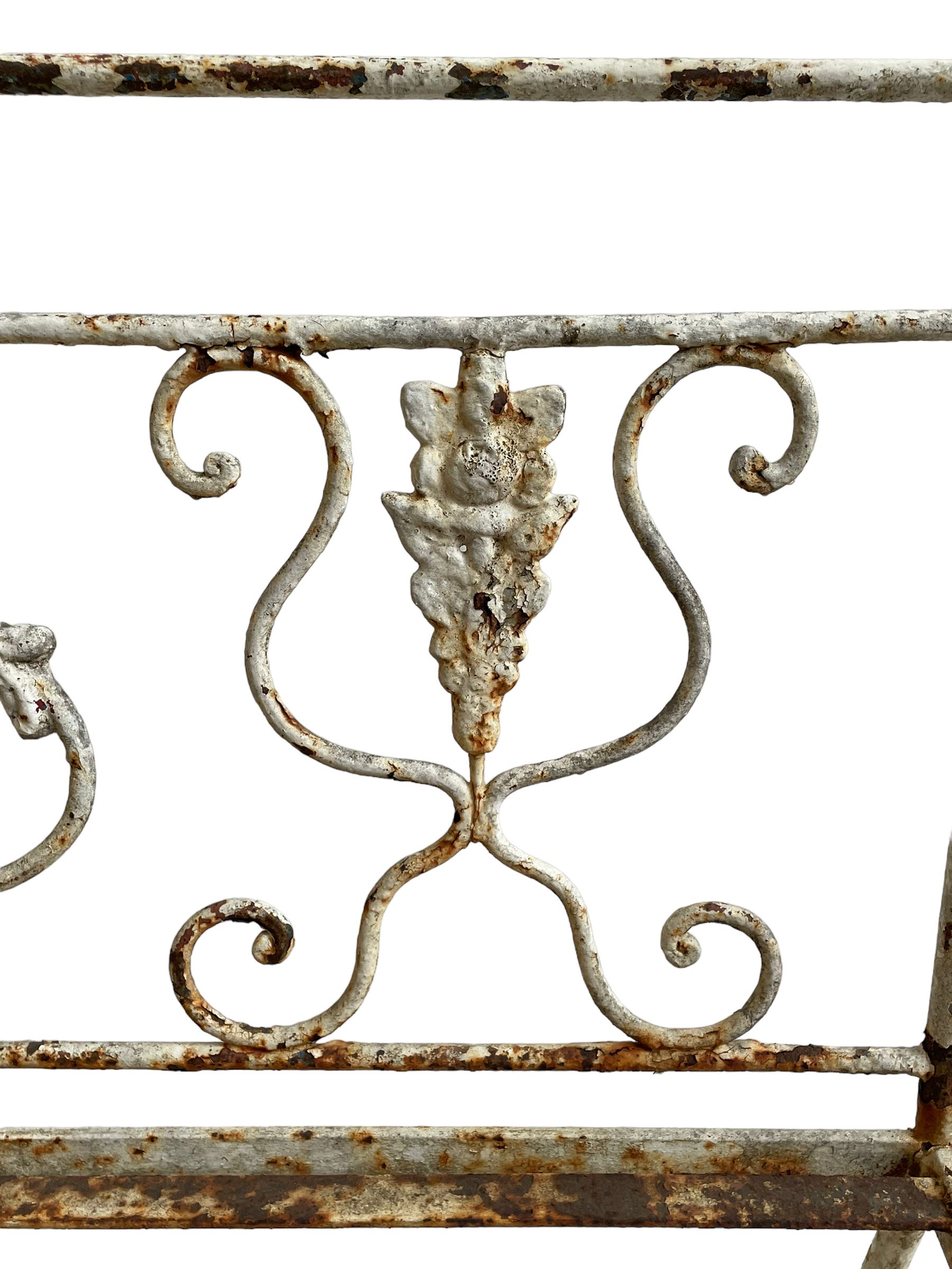 Regency design wrought metal garden bench, central lyre back with foliate S-scrolls with serpent masks, flanked by two floral mouldings and further scrolling, metal slatted seat on straight supports joined by H-stretcher  - THIS LOT IS TO BE COLLECTED BY APPOINTMENT FROM DUGGLEBY STORAGE, GREAT HILL, EASTFIELD, SCARBOROUGH, YO11 3TX