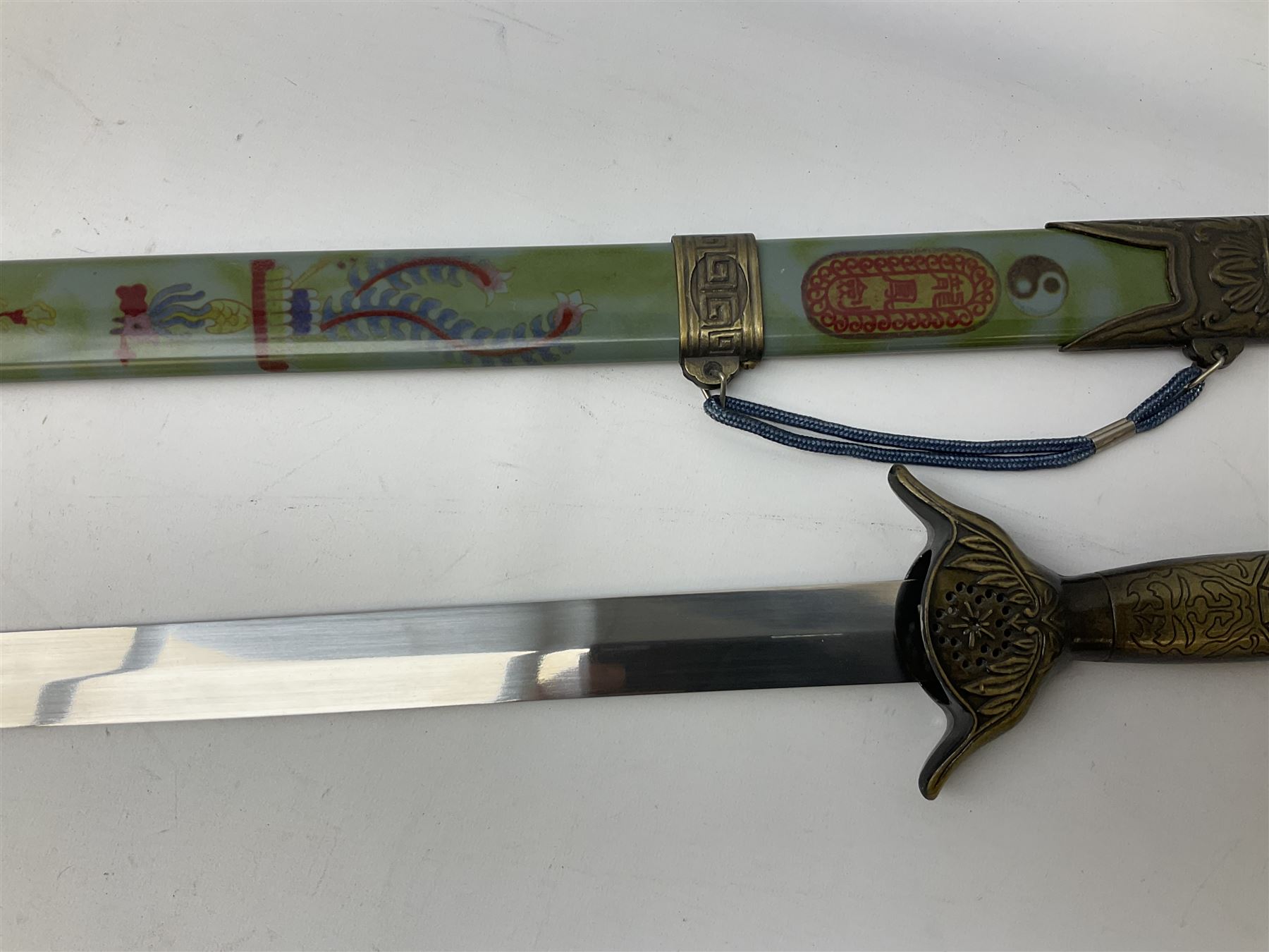 Three reproduction swords - Japanese katana and saya; Tai Chi sword with ornate scabbard; and dress sword with fullered triangular blade and horn handle (3)
