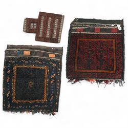 Three late 20th century Persian Baluch wool rugs, two saddlebag rugs together with a salt ...