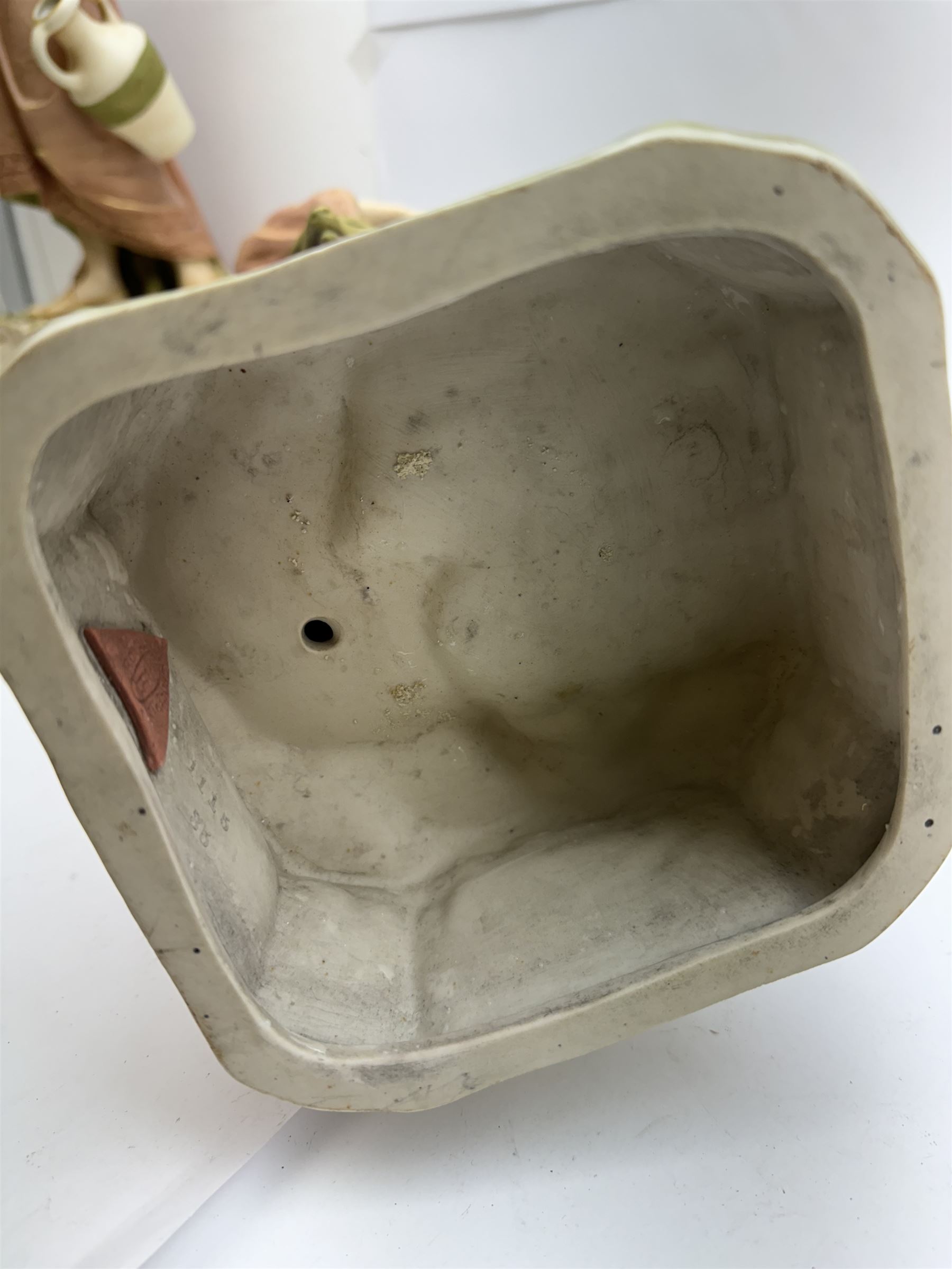 Pair of Royal Dux figures, no. 1115, modelled as a shepherd with a goat by his side and a shepherdess feeding a lamb, each wearing flowing green and pink robes with gilt detailing, with pink triangle mark beneath, H51cm