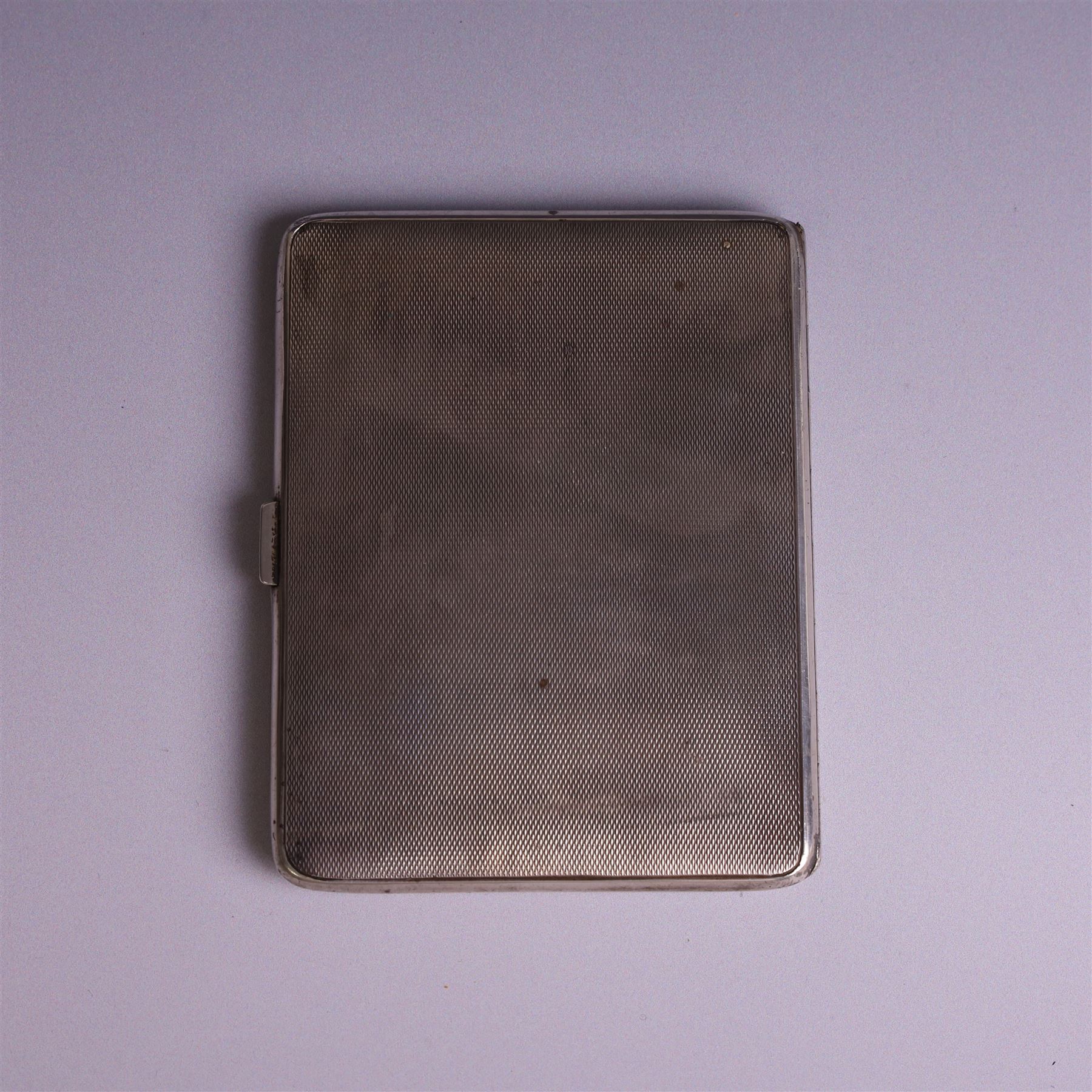 1930s silver cigarette case, of rectangular form with rounded corners, with engine turned decoration throughout, with personal engraving to interior, hallmarked Padgett & Braham Ltd, London 1931, L 11cm 