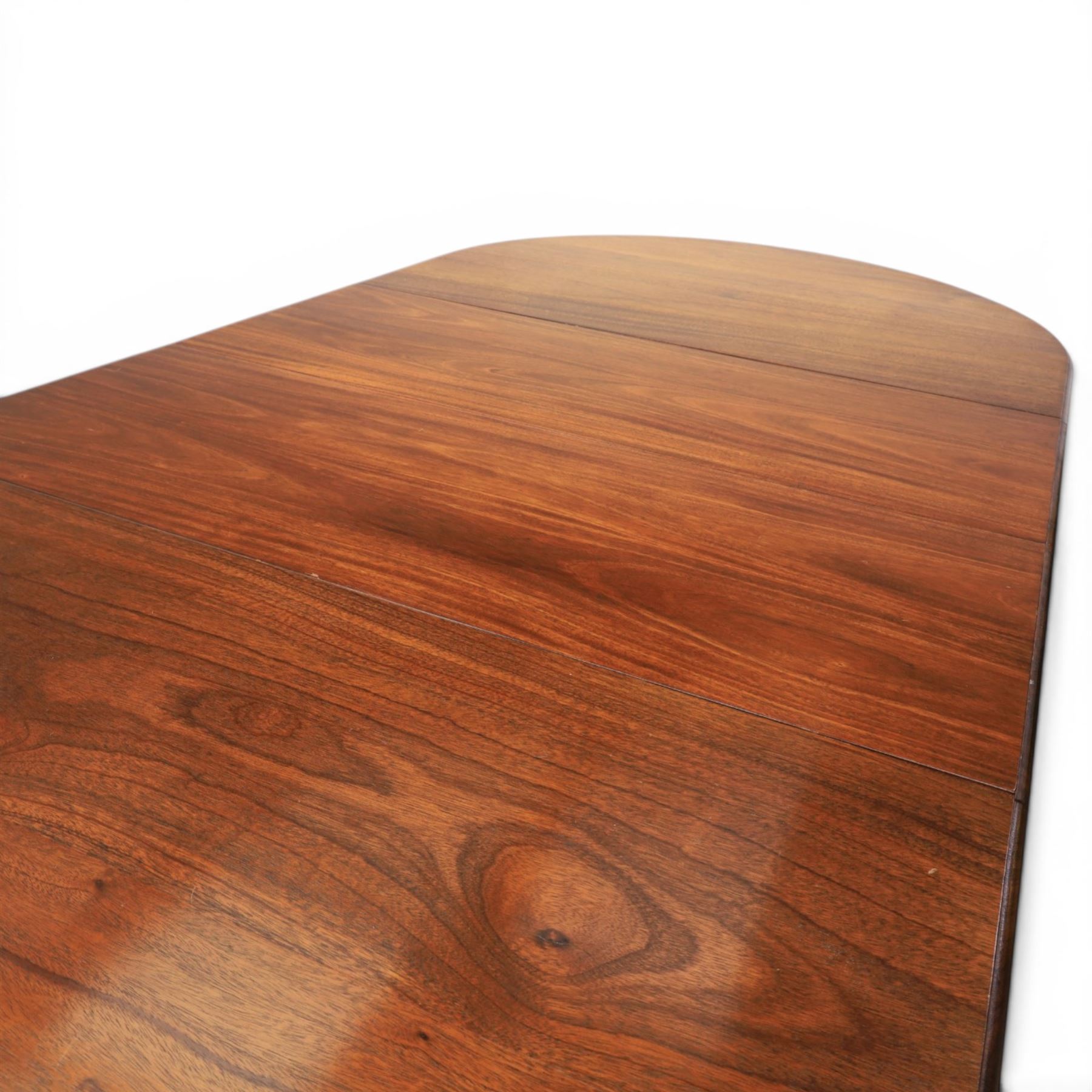 Regency design mahogany extending twin pedestal dining table with two additional leaves, raised on splayed supports terminating brass paw feet
Extends to 268cm