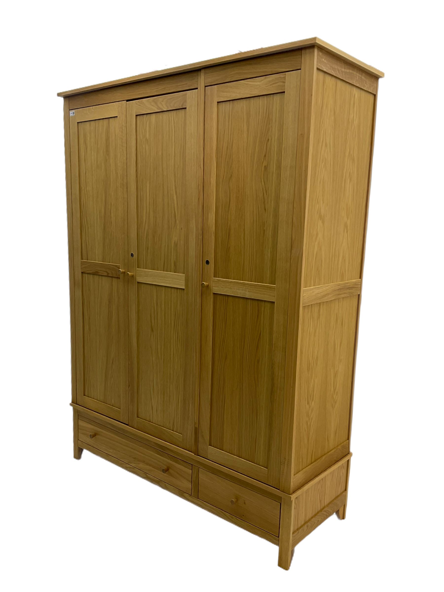 Corndell Furniture - light oak triple wardrobe, enclosed by three panelled doors, one long and one short drawer