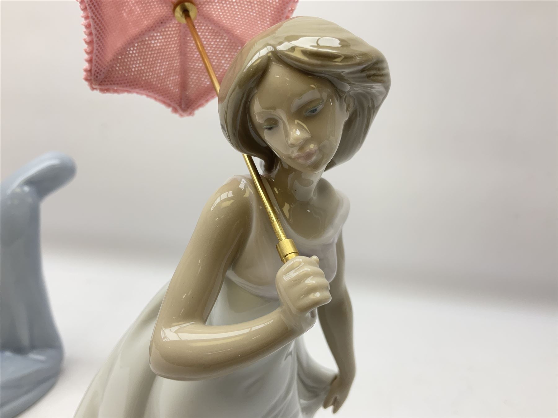 Four Lladro figures, comprising Afternoon Promenade no 7636, Nostalgia no 5071, both with original boxes, Girl with Lilies no 4972 and Madonna no 4534, largest example H27cm