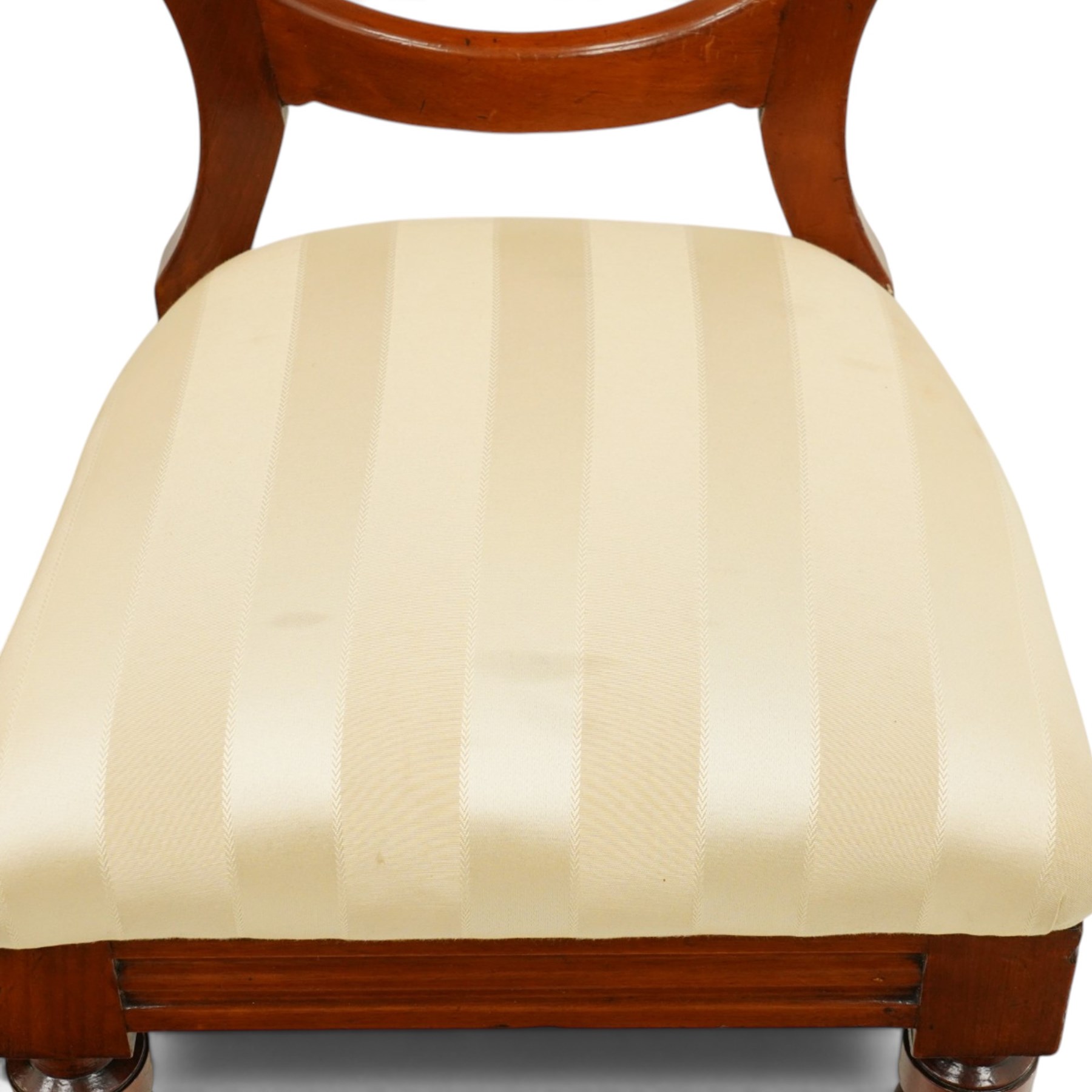 Set of twelve Victorian walnut balloon-back dining chairs, shaped open back over seats upholstered in striped ivory fabric, moulded seat rail above turned and tapering suppors