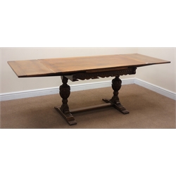  20th century oak extending dining table, two baluster supports on sledge feet joined by a single floor stretcher, W76cm, H73cm, D214cm (maximum measurements)   