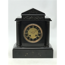  Victorian black slate mantle clock, black and gilt circular Roman dial, flanked by reeded columns below classical bronze frieze, twin train movement striking the hours on a gong, H30.5cm   