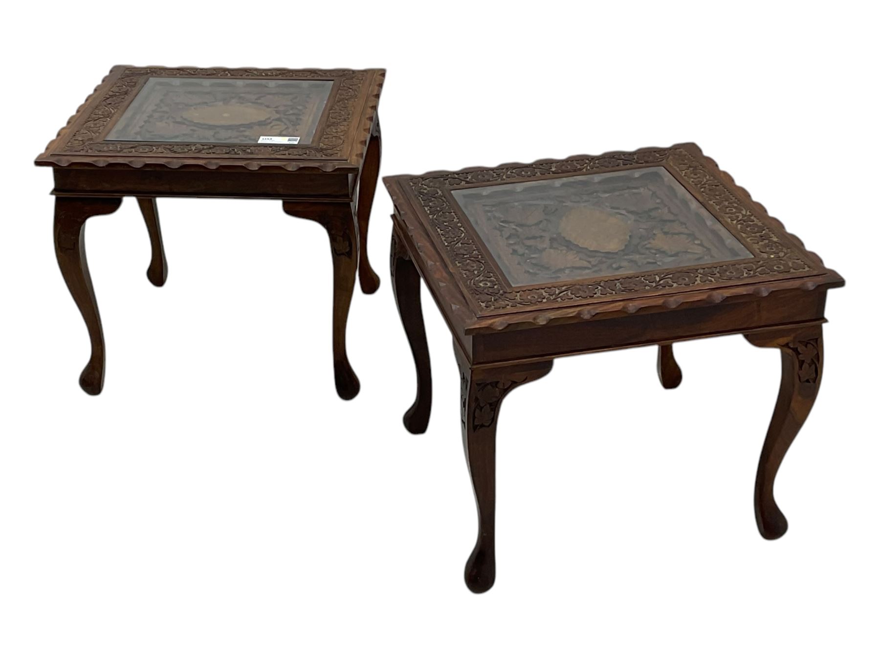 Pair of Pakistan carved hardwood brass inlaid lamp tables, square form, cabriole legs, inset glass tops