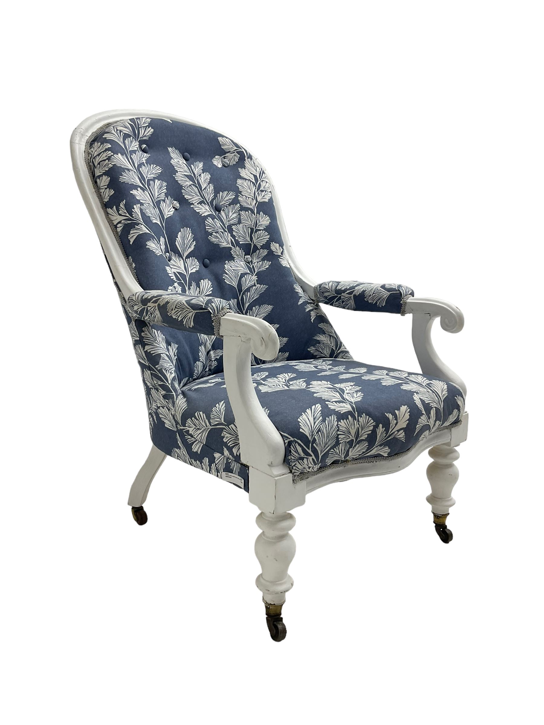 Victorian white painted open armchair, upholstered in blue fabric decorated with trailing leaf pattern, scrolled arm terminals on turned front supports with castors