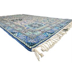 Morrocan single weft blue ground rug, the field segmented into a grid of ten rectangular panels, bordered by a series of guard bands with repeating floral and geometric patterns with interlocking vines and rosettes, the edges finished with a fringe of twisted tassles
