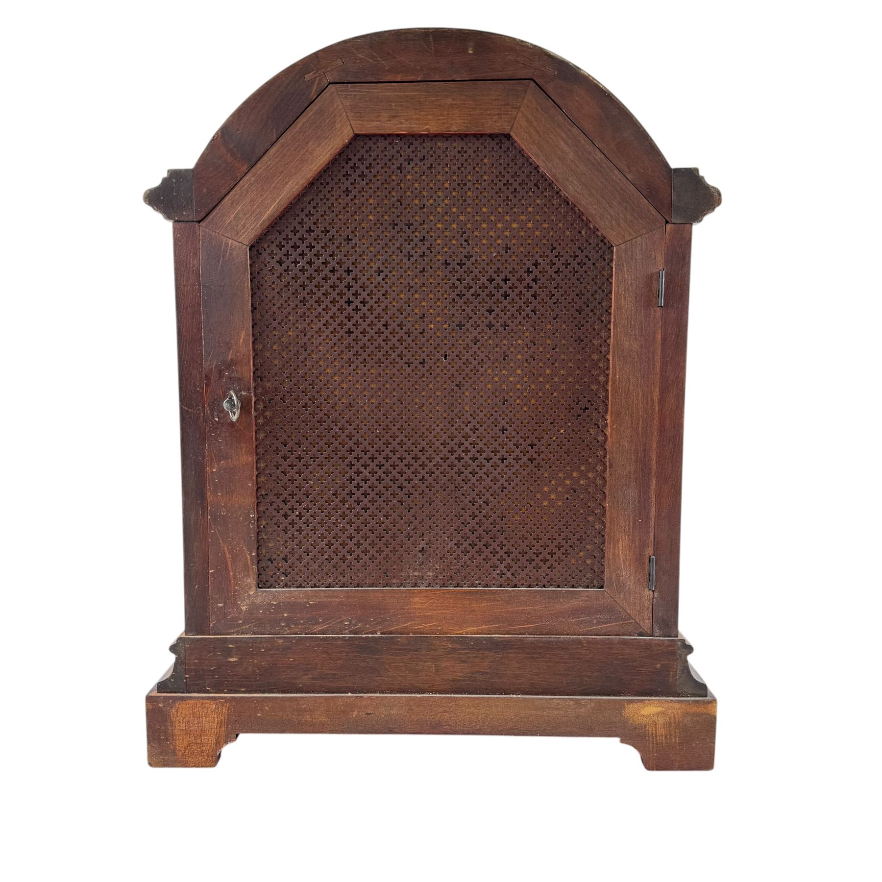 Gustav Becker, German 20th century 8-day mahogany cased mantle clock, break arch mahogany case with a round topped door flanked by reeded pilaster with Ionic capitals and raised on a stepped plinth, the dial with engraved Roman numerals, with steel fleur di Lis hands, and  chime /silent dial, H43cm