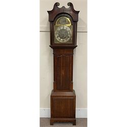 Early 19th century oak and mahogany longcase clock, scrolling pediment over stepped arch glazed door, plain turned pilaster columns, the brass and silvered dial with circular plate depicting a three mast ship at sea, scrolling leaf decoration, Roman and Arabic chapter ring, subsidiary seconds dial, the trunk door inlaid with shell motif and flanked by canted corners with fluted quarter columns, the base with raised panel inlaid with fan motif, on shaped apron with bracket feet