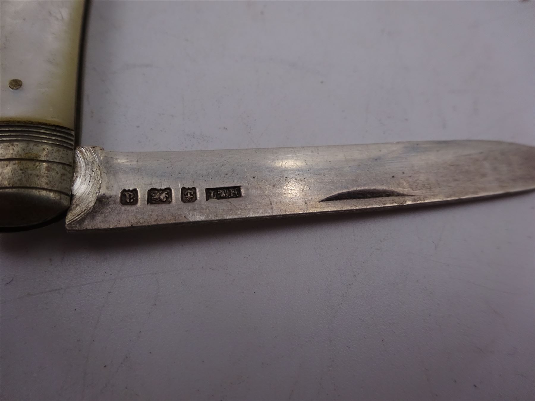 1920s silver mounted cigarette box, of rectangular form, with engraved initials and engine turned decoration to hinged cover, opening to reveal softwood interior, hallmarked E J Trevitt & Sons, Chester 1929, together with a silver handled button hook and shoe horn, and a mother of pearl handled silver fruit knife, all hallmarked, cigarette case W11.5cm, D8.5cm, H3.5cm