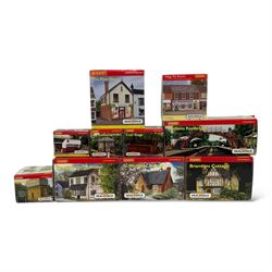 Ten Hornby '00' gauge Skaledale buildings, comprising R9834 Village Tea Rooms, R8506 Brambles Cottage, R8507 Platt's General Store, R8503 St Michaels School, R9769 The Pine Shop, R8641 Platform Footbridge, R8639 Water Tower, R8587 Coal Stage, R8589 Level Crossing Signal Box and R8638 Platform Shelter, all boxed