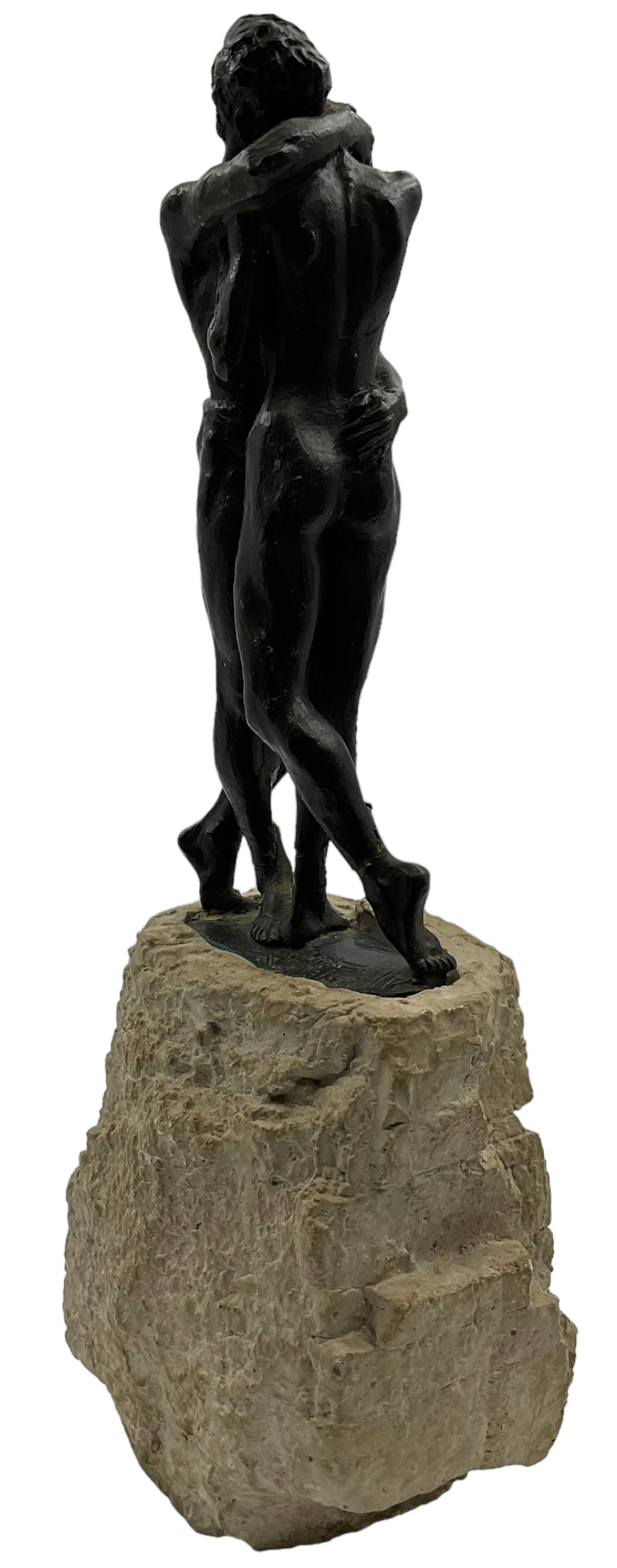 Composite sculpture embracing couple, after Joseph Bofill on a rocky base, height 33cm.