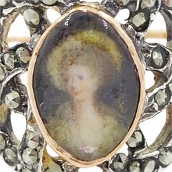 19th century gold and silver marcasite portrait ring, set with an oval miniature of a woman on ivory, under a glazed panel, with a marcasite and red stone set crossover surround, with pierced gold shoulders and reeded shank. This lot has been registered for sale under Section 10 of the APHA Ivory Act