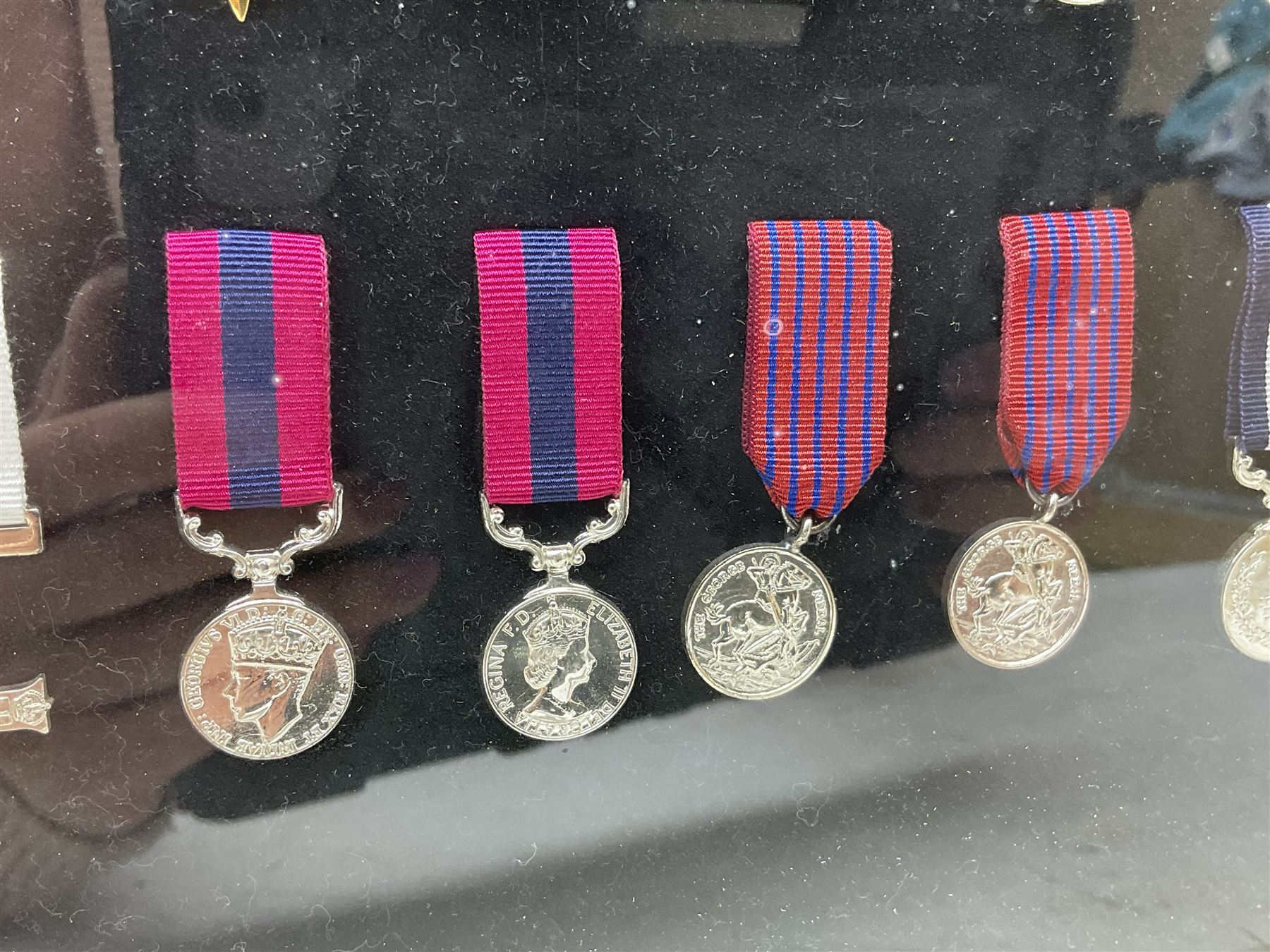 Limited edition large framed display board with sixty half-size copies of British Gallantry and Campaign Medals produced by Danbury Mint; all with ribbons and associated booklet