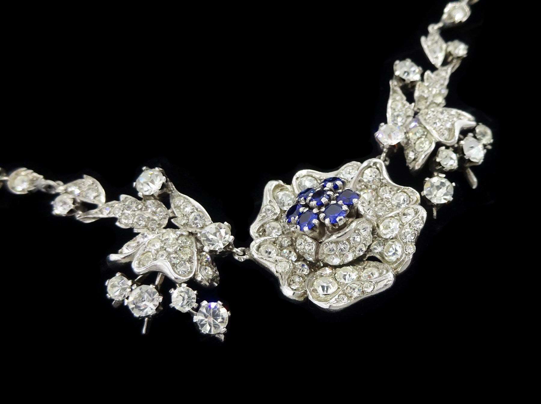 Silver synthetic sapphire and white paste stone set flower necklace, brooch and matching pair of earrings, stamped sterling