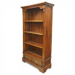 Late 20th century Georgian design hardwood open bookcase, moulded cornice above a shaped frieze, open shelved interior with boarded back, the base fitted with two short drawers with brass swan neck handles, on a shaped plinth