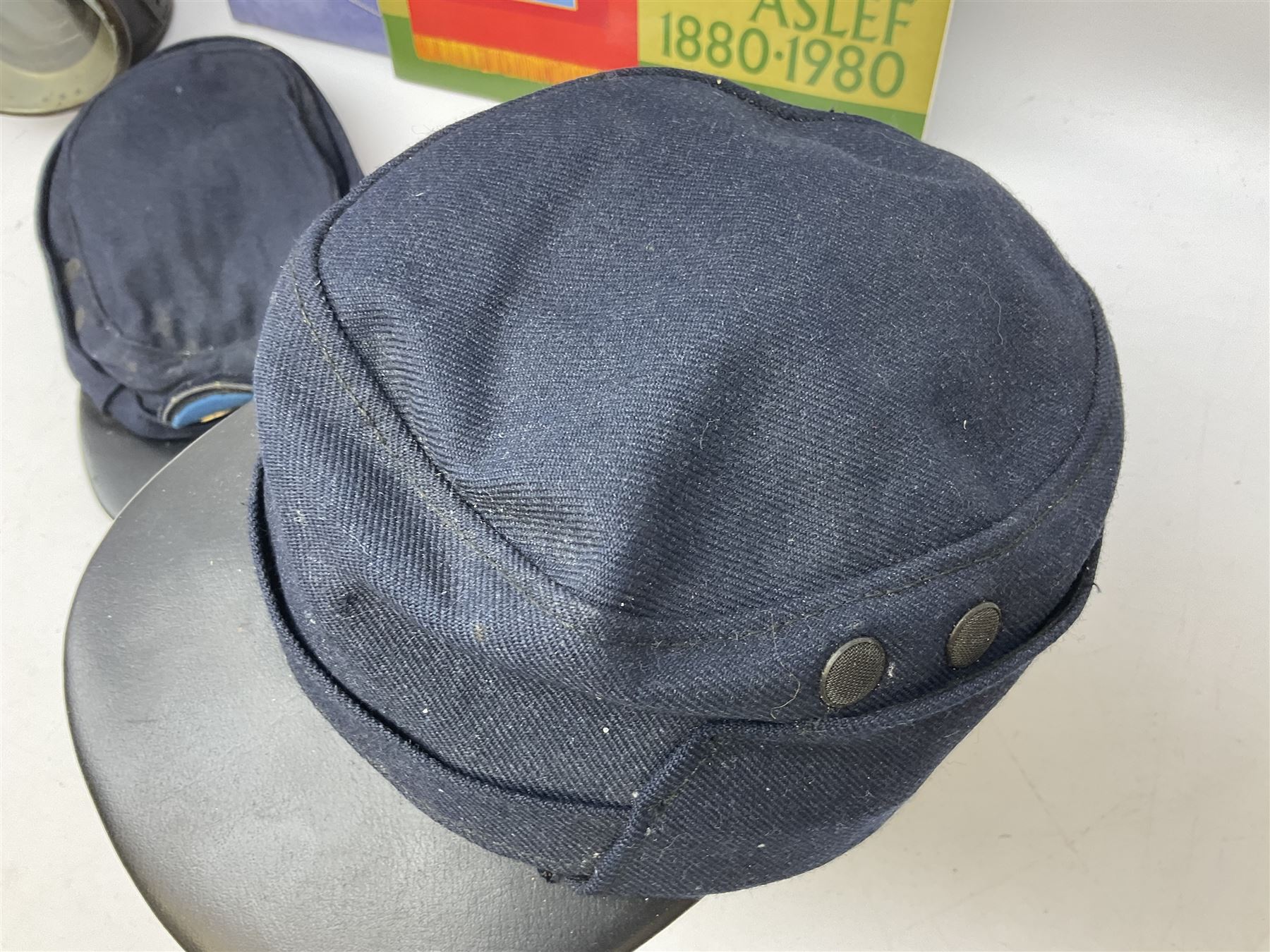 Black painted three colour railway lamp with revolving filters, H29cm; BR Acme Thunderer whistle; three railway peaked caps, two with BR Intercity 125 badge; small album of photographs of railway interest etc