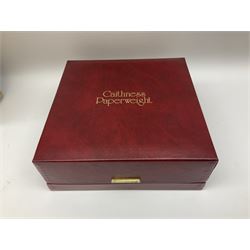 Set of four Caithness paperweights titled Four Seasons, in presentation box with certificate, designed by Colin Terris and made by William Mason, each internally decorated with a seasonal flower within a millefiori cane work garland, numbered 128 of 500