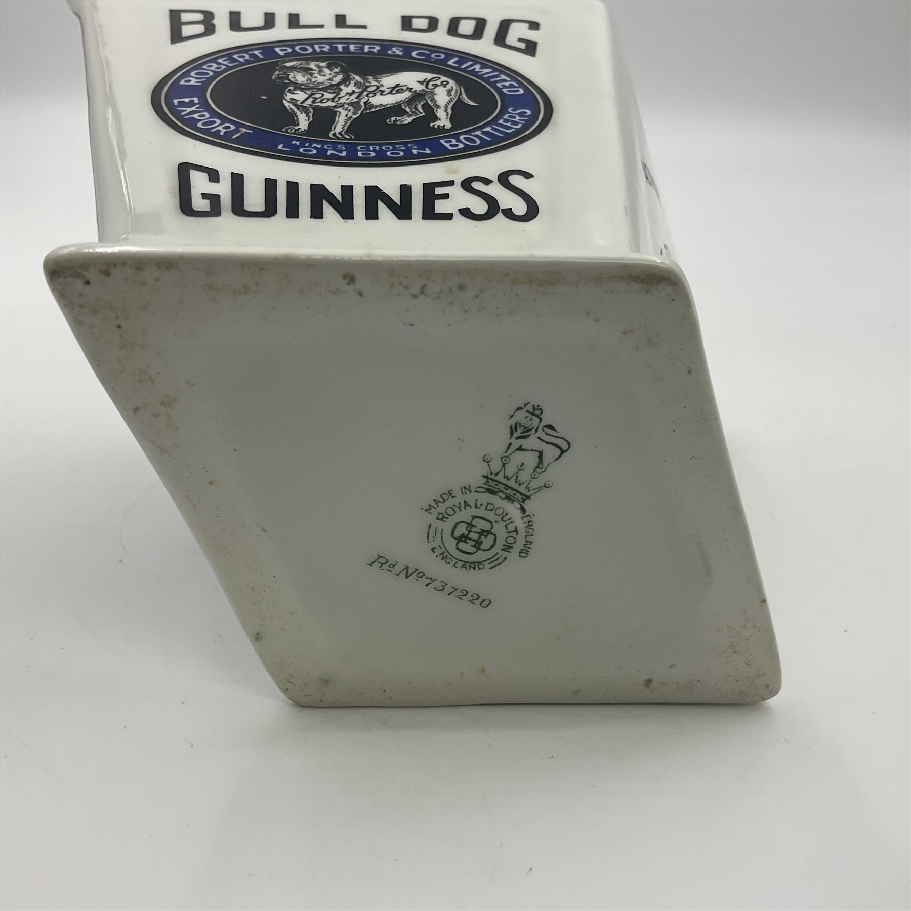 Royal Doulton Guinness advertising whiskey water jug, circa 1930s by Robert Porter and Co. of lozenge angled form, decorated with the  bulldog Guinness, H11cm