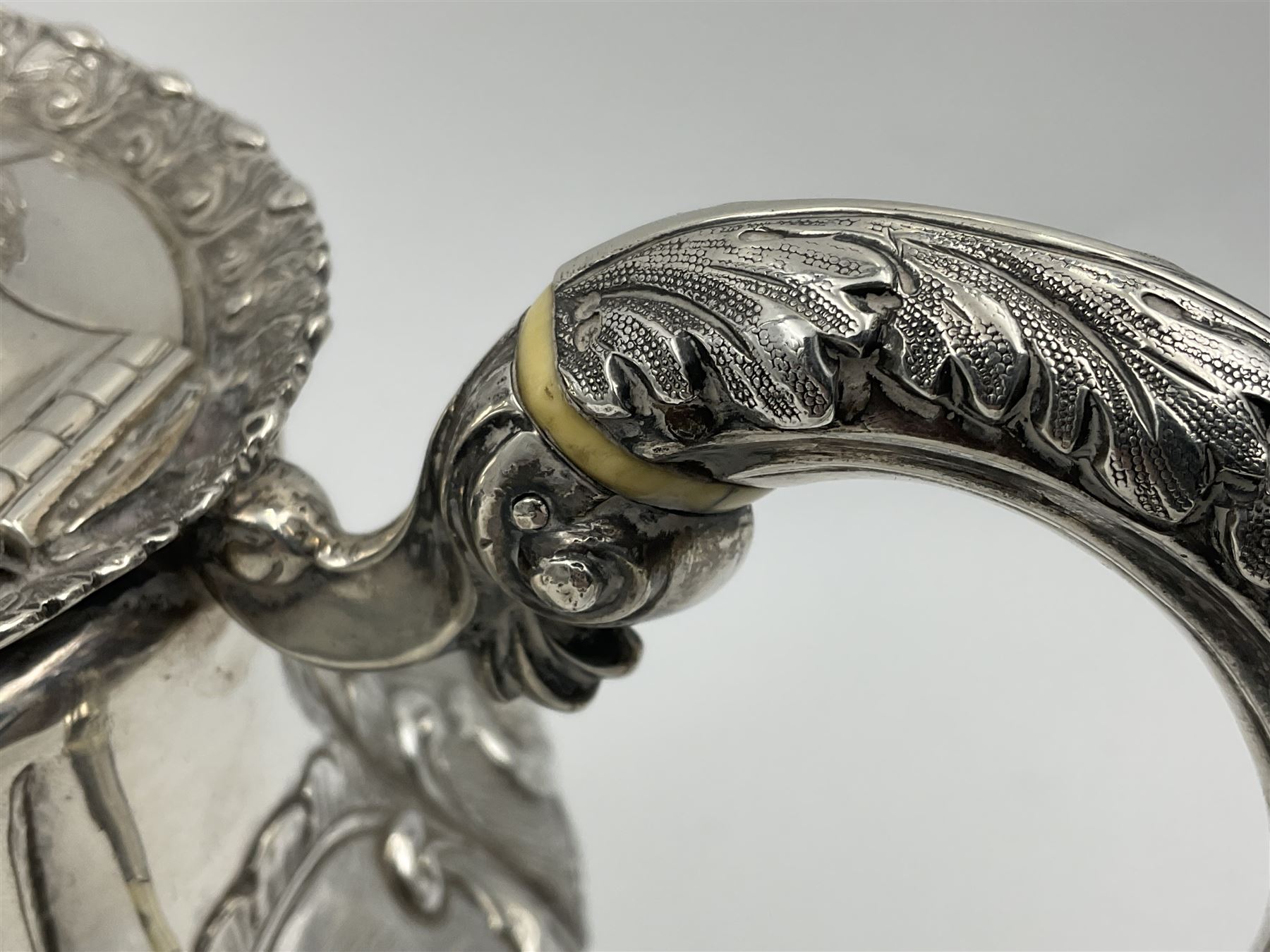 Victorian silver three piece tea service, comprising teapot, twin handled open sucrier, and milk jug, each of bellied form with acanthus capped scroll handles, the sides embossed with alternating scroll edged vacant panels and panels containing a pair of birds, upon four palmette feet, the teapot with ivory insulators to handle, and bird finial to the hinged domed cover, hallmarked William Hunter & Son, London 1861, teapot H19cm, including handles sucrier H13.5cm, including handle milk jug H12cm

This item has been registered for sale under Section 10 of the APHA Ivory Act