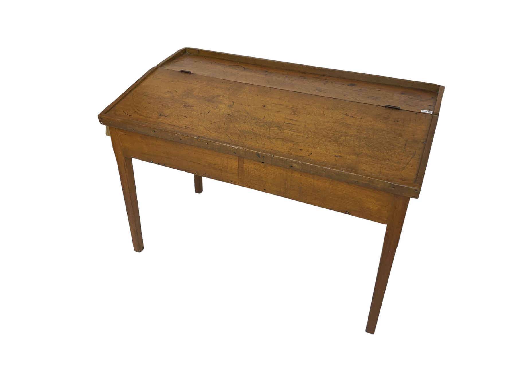 Late 19th century walnut school desk, sloped hinged lid, on square tapering supports 