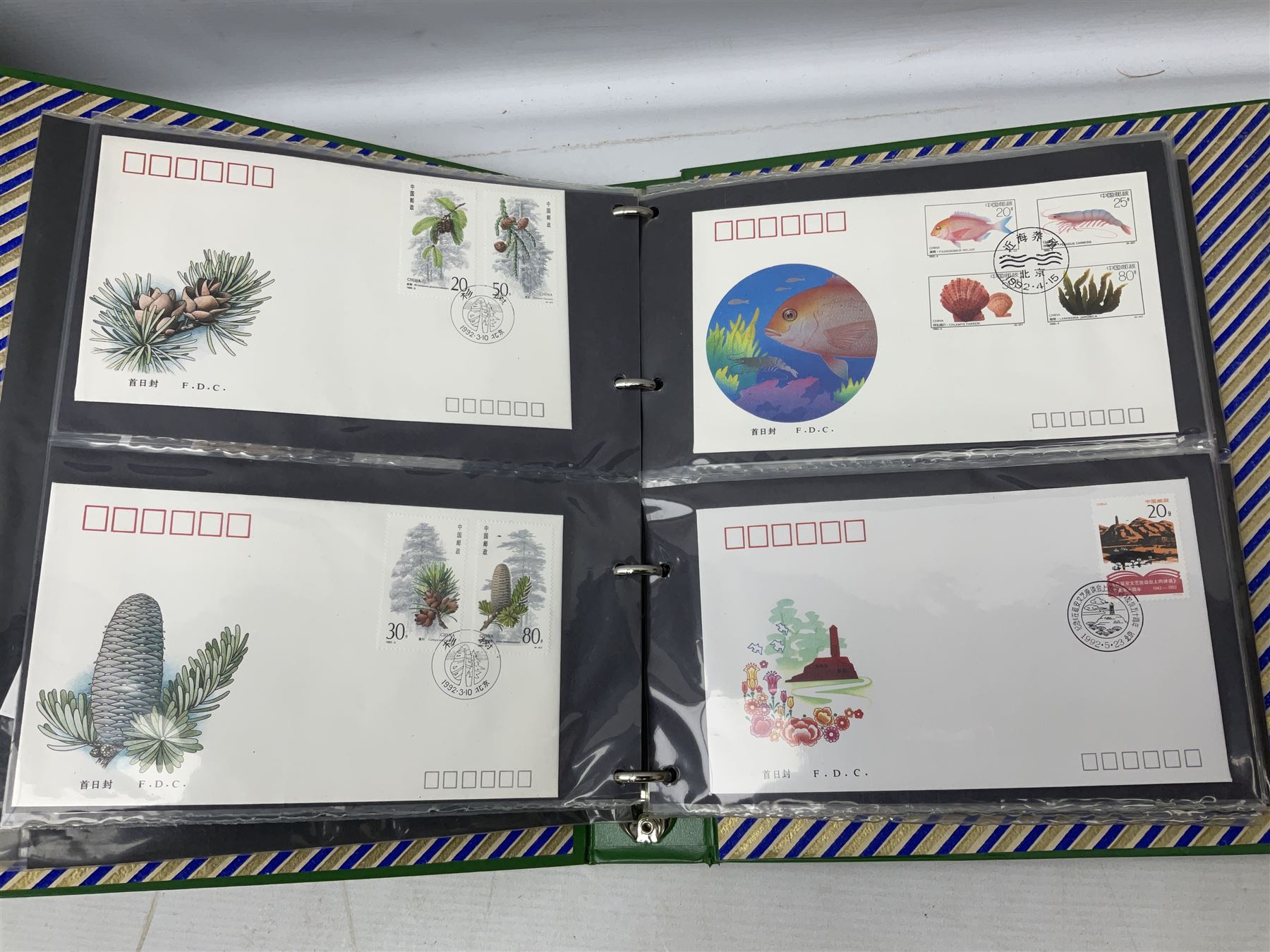 Mostly Chinese stamps including  covers and postcards, many being from the 80s and 90s, housed in ten folders