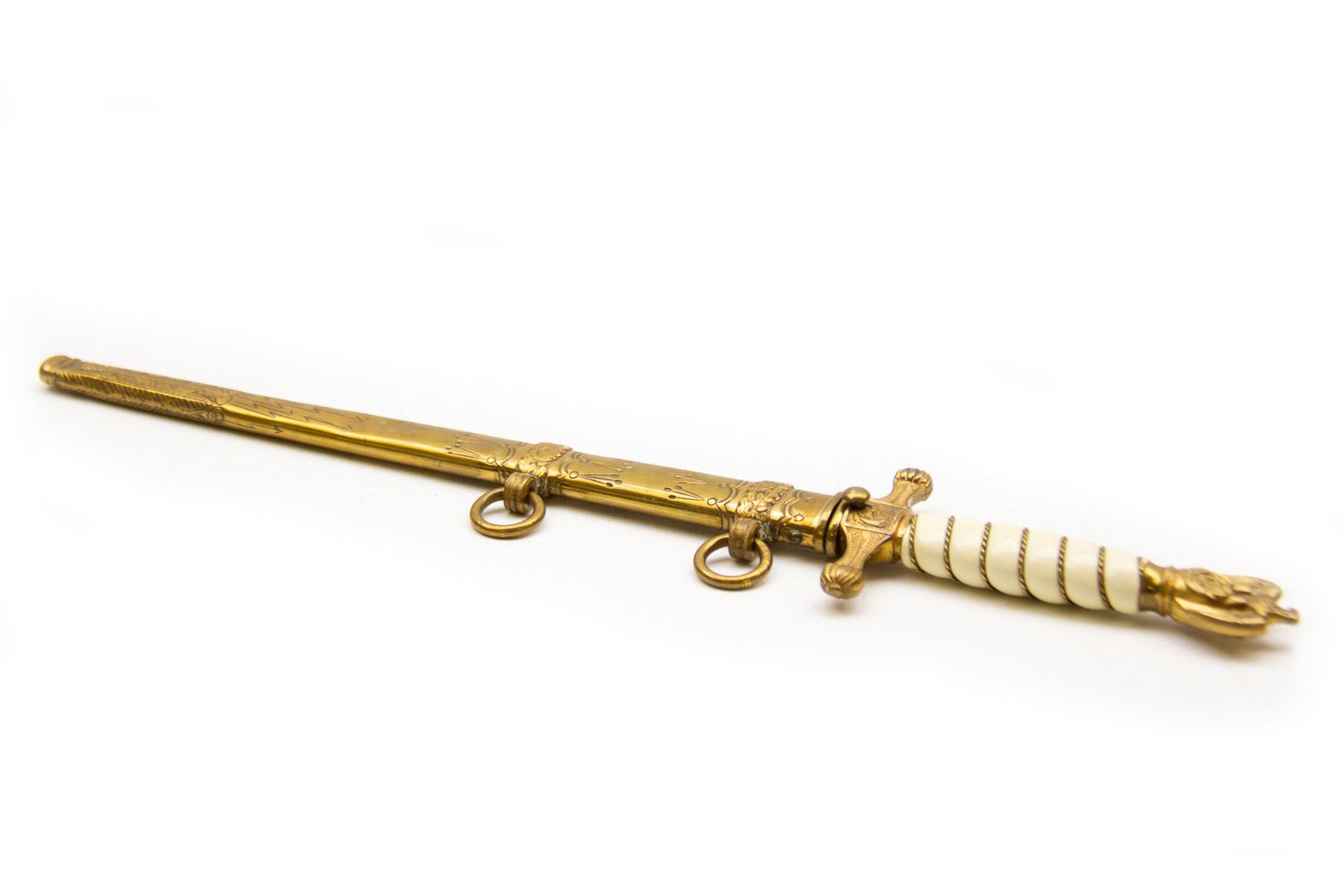 WWII period German Kriegsmarine navel officers dress dagger by Carl Eickhorn, Solingen, with gilded pommel and cross guard with press stud release button, white celluloid grip with wire binding, housed in its original brass scabbard with two hanging rings, the etched double edged blade with Carl Eickhorn, Solingen makers trademark to the base, L39cm