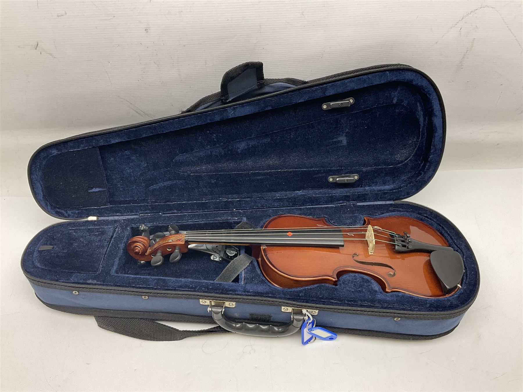Four student violins - two Chinese three-quarter size with 33.5cm and 34cm two-piece backs; Stringers of Edinburgh quarter size with 28cm two-piece back; and Stentor quarter size with 28cm two-piece back; each in carrying case (4)