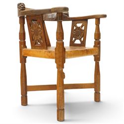 Mouseman - important oak monks chair, c1930s, the curved back inscribed with motto 'Cum Bona Voluntate Servientes' (serving with goodwill) over Trinity College Cambridge coat of arms, the shaped arms terminating with carved monks heads, each pierced side panel with Yorkshire Rose, tan leather seat on four octagonal legs joined by a cross stretcher, the back of the chair with initials ECH, with carved mouse signature, by Robert Thompson of Kilburn