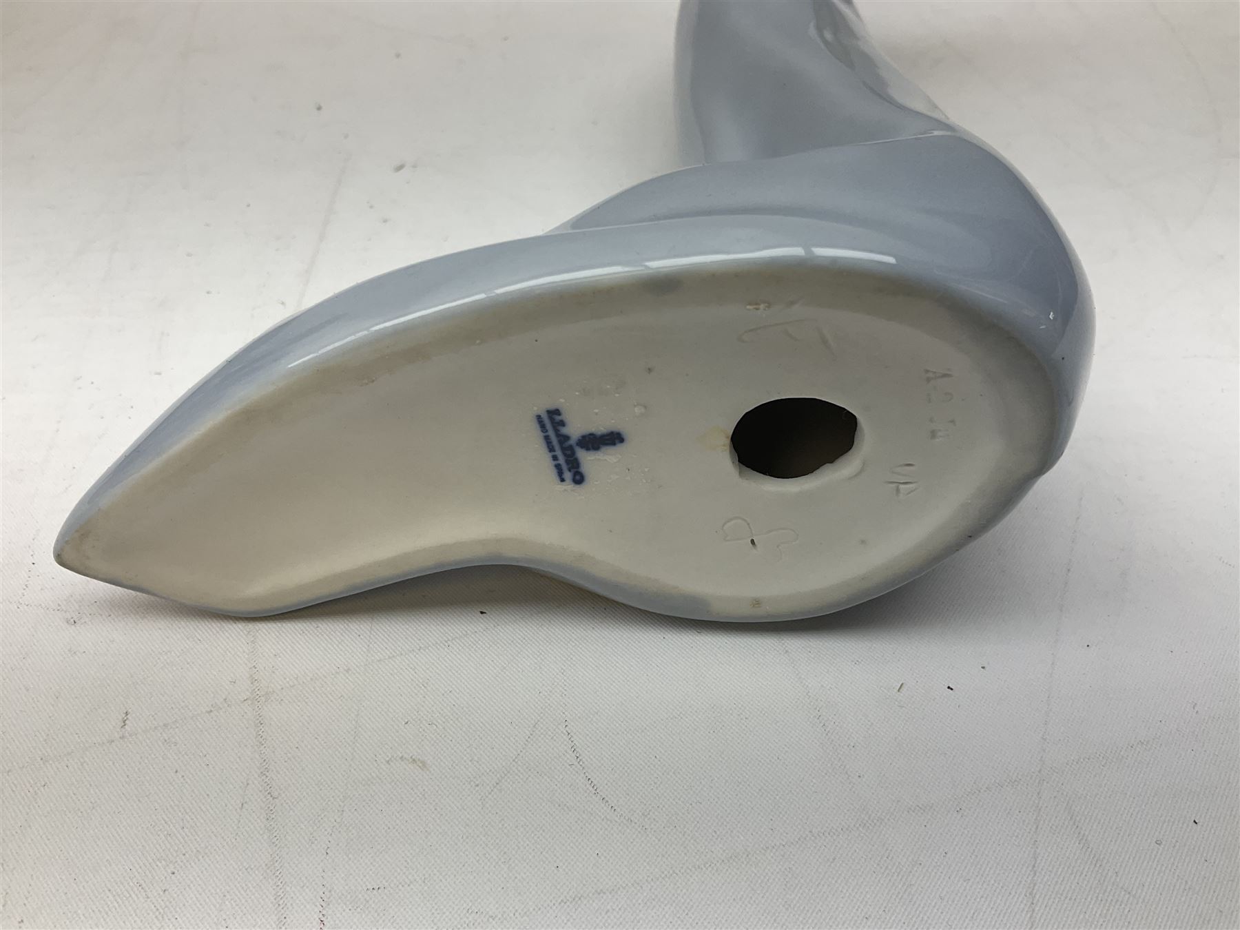 Four Lladro figures, comprising Afternoon Promenade no 7636, Nostalgia no 5071, both with original boxes, Girl with Lilies no 4972 and Madonna no 4534, largest example H27cm