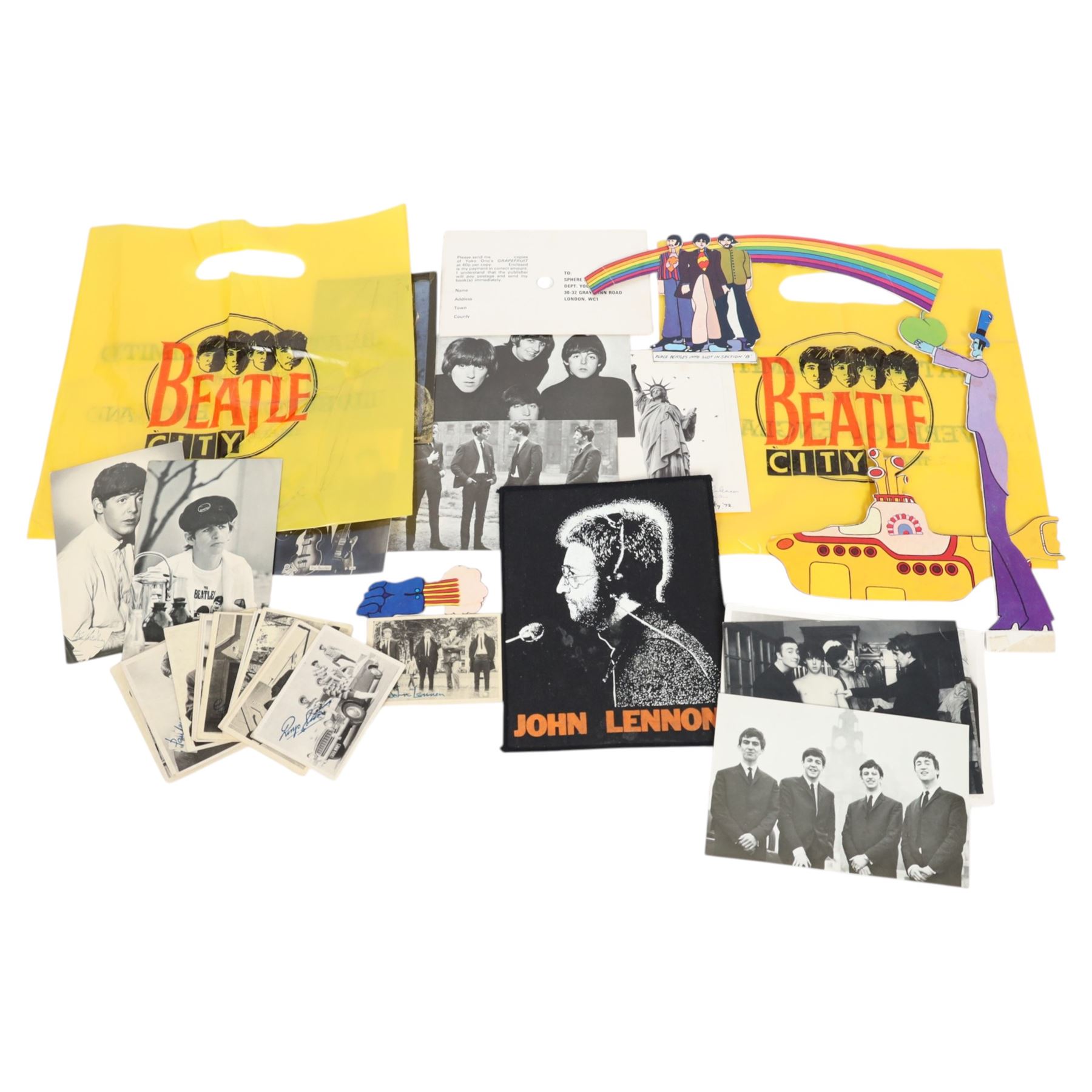 Beatles memorabilia, comprising John Lennon patch, nineteen Beatles chewing gum cards, collection of photographs and postcards including Eskimo Frozen Foods examples, two Beatles City carrier bags and Yellow Submarine cardboard cut-outs