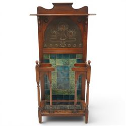 Shapland & Petter of Barnstaple - Arts & Crafts mahogany tile-backed umbrella or stick hall-stand, model no.114, the shaped back with single shelf over an Art Nouveau embossed patinated copper panel and turquoise tiled back, with turned supports and dividers over inset metal drip tray

Notes: A comparable Shapland & Petter stick stand of this model is recorded in Daryl Bennett, Shapland & Petter Ltd of Barnstaple, Museum of Barnstaple and North Devon, p.84, cat. no.5.37, and the model is also listed in Bennett, Liberty’s Furniture 1875-1915, p.298, cat. no.8.6. Examples of this model are known to have been retailed by Liberty & Co.