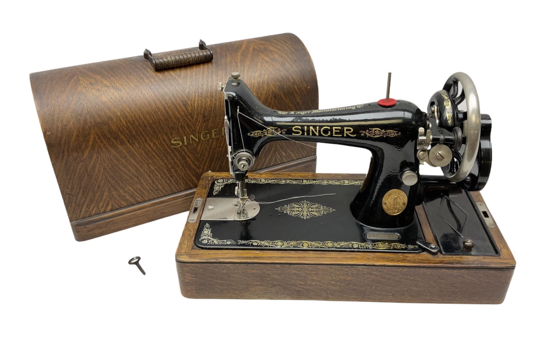 Singer sewing machine in wood case with key Antiques