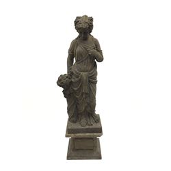 Hand carved stone classical female figure carrying flowers on plinth base