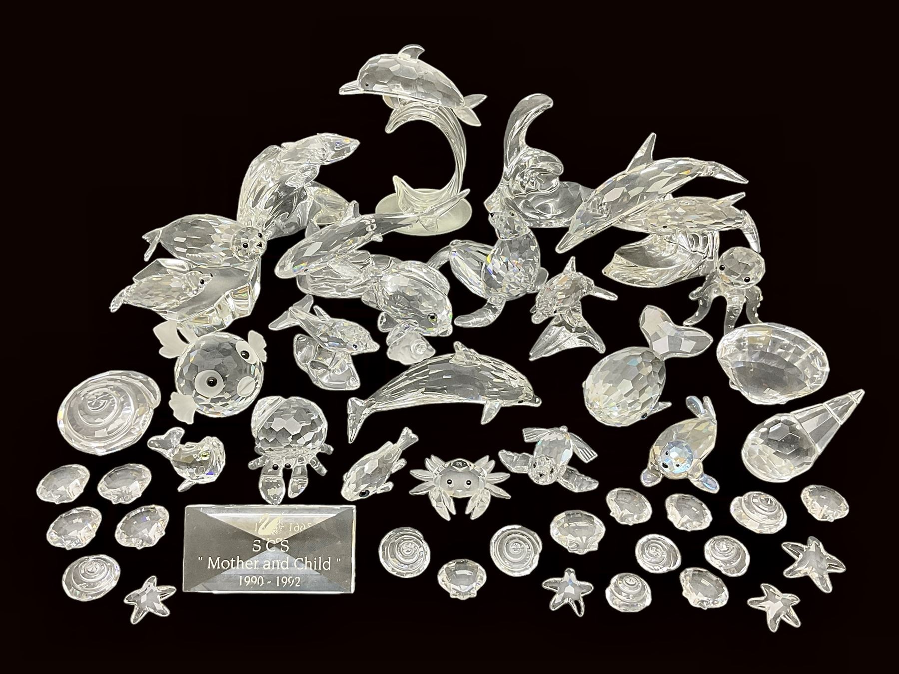 Nineteen Swarovski Crystal sea creatures, to include dolphins, seals, puffer fish, octopus, crabs, together with a quantity Swarovski Crystal shells 